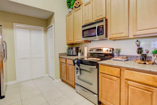 a kitchen with stainless steel appliances granite countertop a sink and a microwave