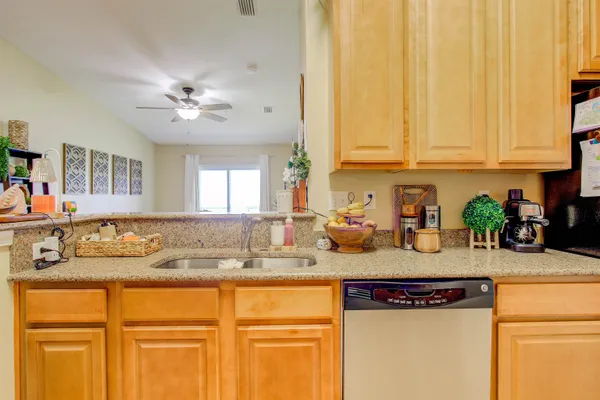 a kitchen with stainless steel appliances granite countertop a sink a stove and cabinets