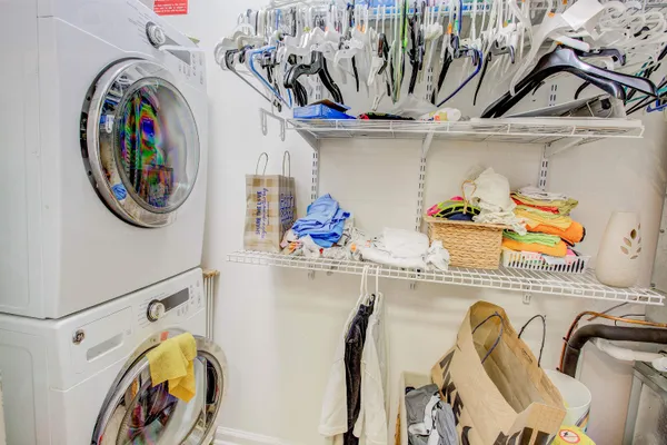 a view of walk in closet with clothes and shoes