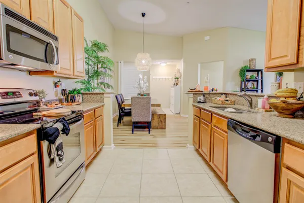 a kitchen with stainless steel appliances granite countertop a sink stove and cabinets