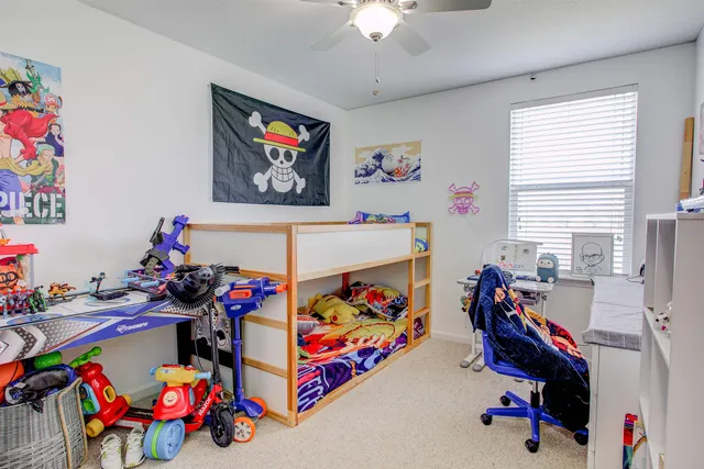 a play room with toys and a chandelier
