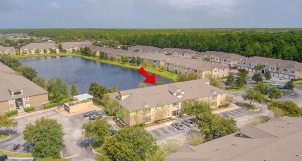 an aerial view of residential houses with outdoor space and river