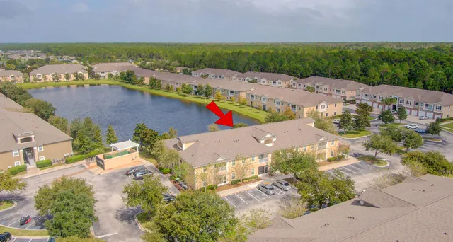 an aerial view of residential houses with outdoor space and river