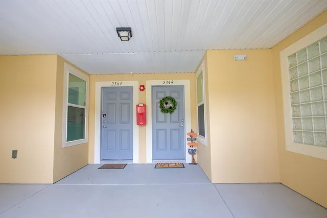 a view of an empty room with window and refrigerator
