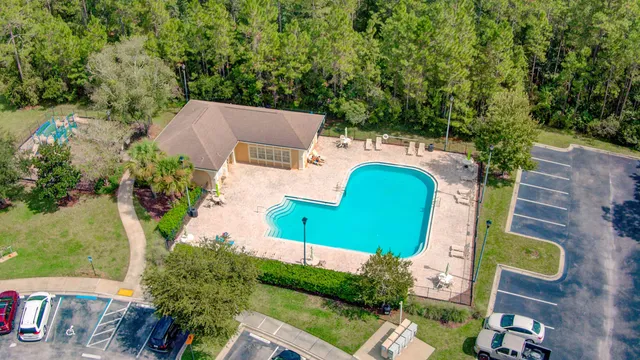 an aerial view of a house with a yard and garden