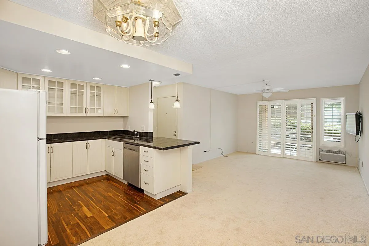 5906 Rancho Mission Road, Unit 5 San Diego, CA 92108 - Photo 1 of 33 a large white kitchen with a stove a refrigerator a sink and a large window