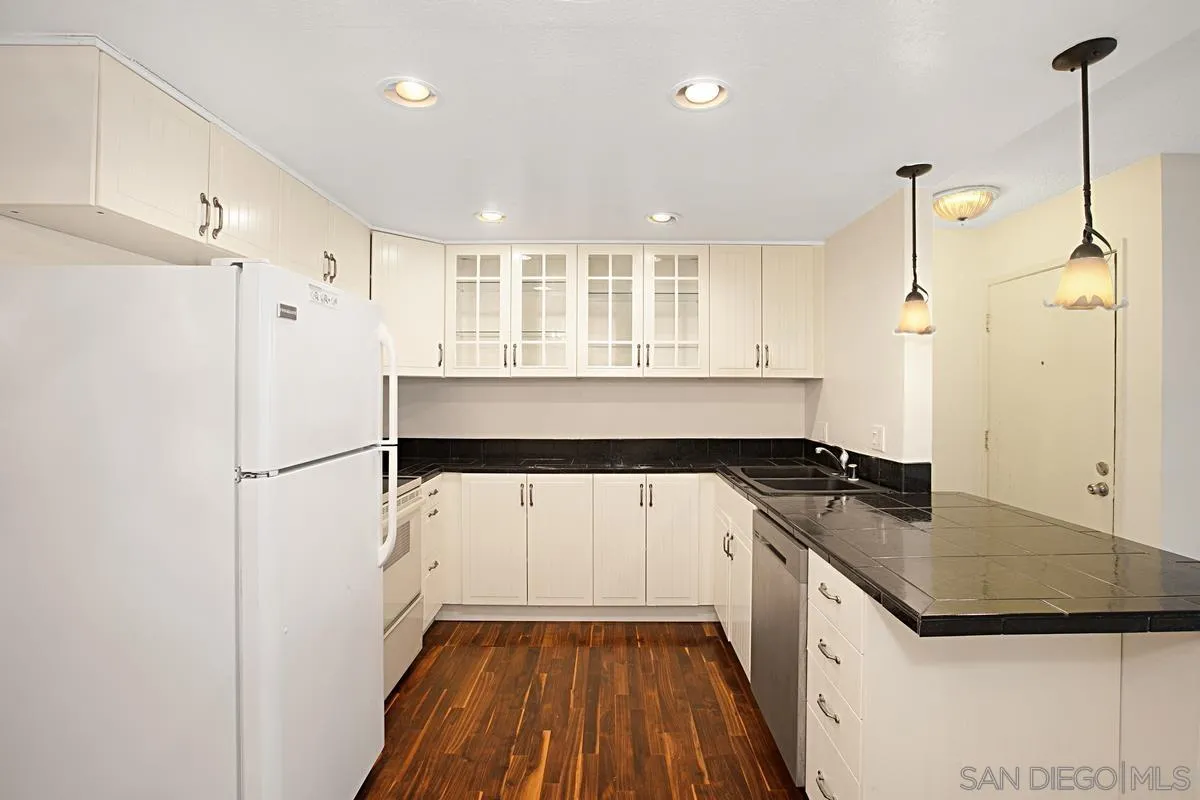 5906 Rancho Mission Road, Unit 5 San Diego, CA 92108 - Photo 11 of 33 a kitchen with a sink stove and refrigerator