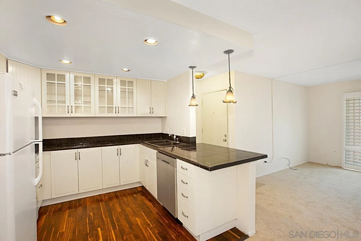 5906 Rancho Mission Road, Unit 5 San Diego, CA 92108 - Photo 12 of 33 a kitchen that has a sink a stove and a refrigerator
