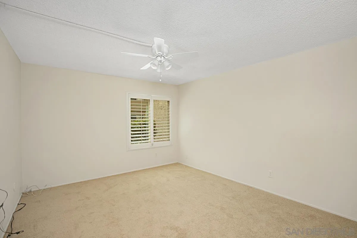 5906 Rancho Mission Road, Unit 5 San Diego, CA 92108 - Photo 14 of 33 an empty room with a empty space and windows