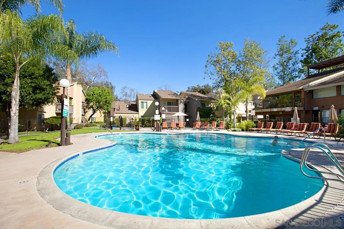 5906 Rancho Mission Road, Unit 5 San Diego, CA 92108 - Photo 21 of 33 a view of a swimming pool with outdoor seating and a tree