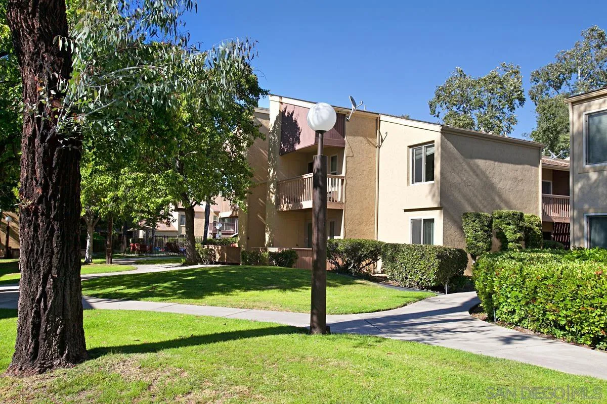 5906 Rancho Mission Road, Unit 5 San Diego, CA 92108 - Photo 30 of 33 a view of a house with a yard
