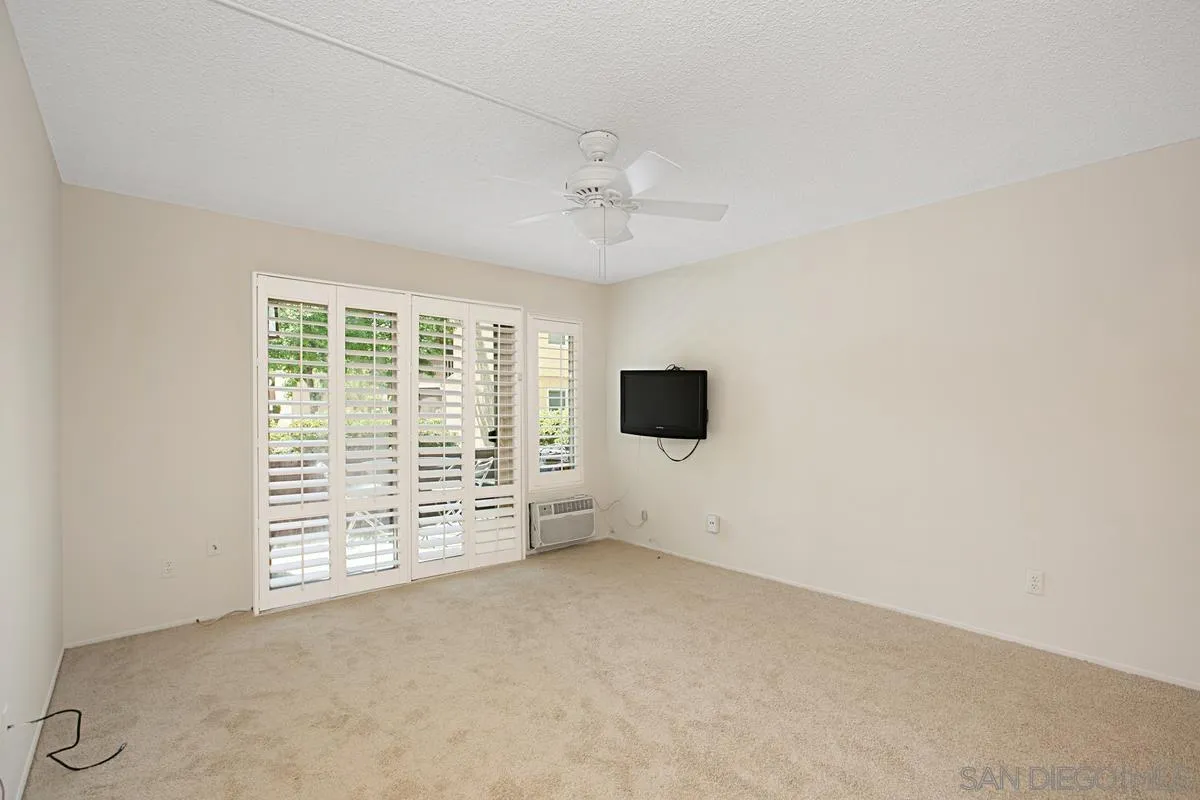 5906 Rancho Mission Road, Unit 5 San Diego, CA 92108 - Photo 4 of 33 an empty room with windows and fan