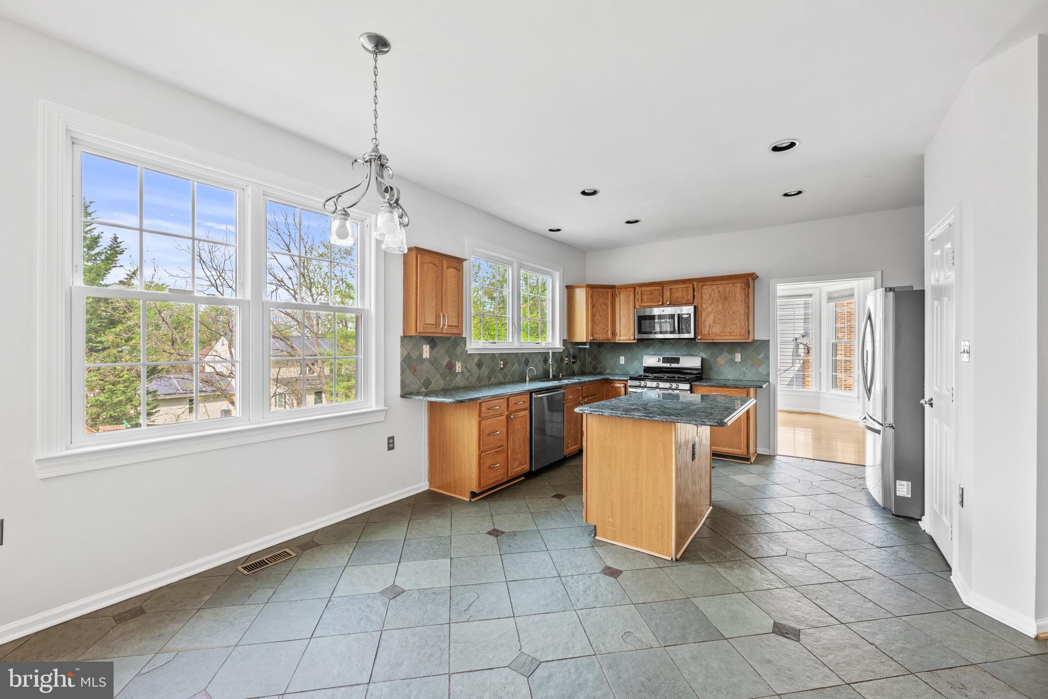 409 Midsummer Drive Gaithersburg, MD 20878 - Photo 11 of 41 a kitchen with a sink a counter top space and appliances