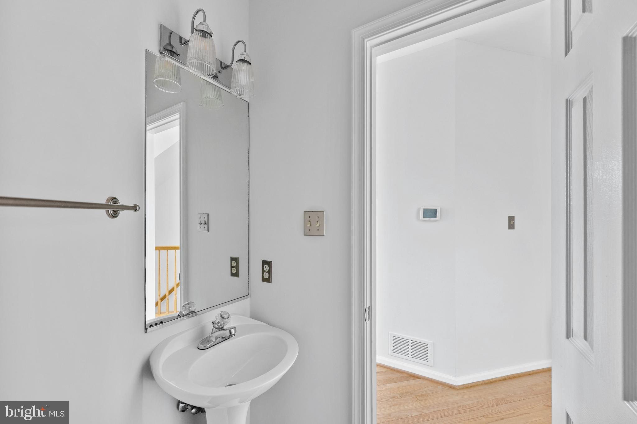 409 Midsummer Drive Gaithersburg, MD 20878 - Photo 20 of 41 a bathroom with a sink and a mirror
