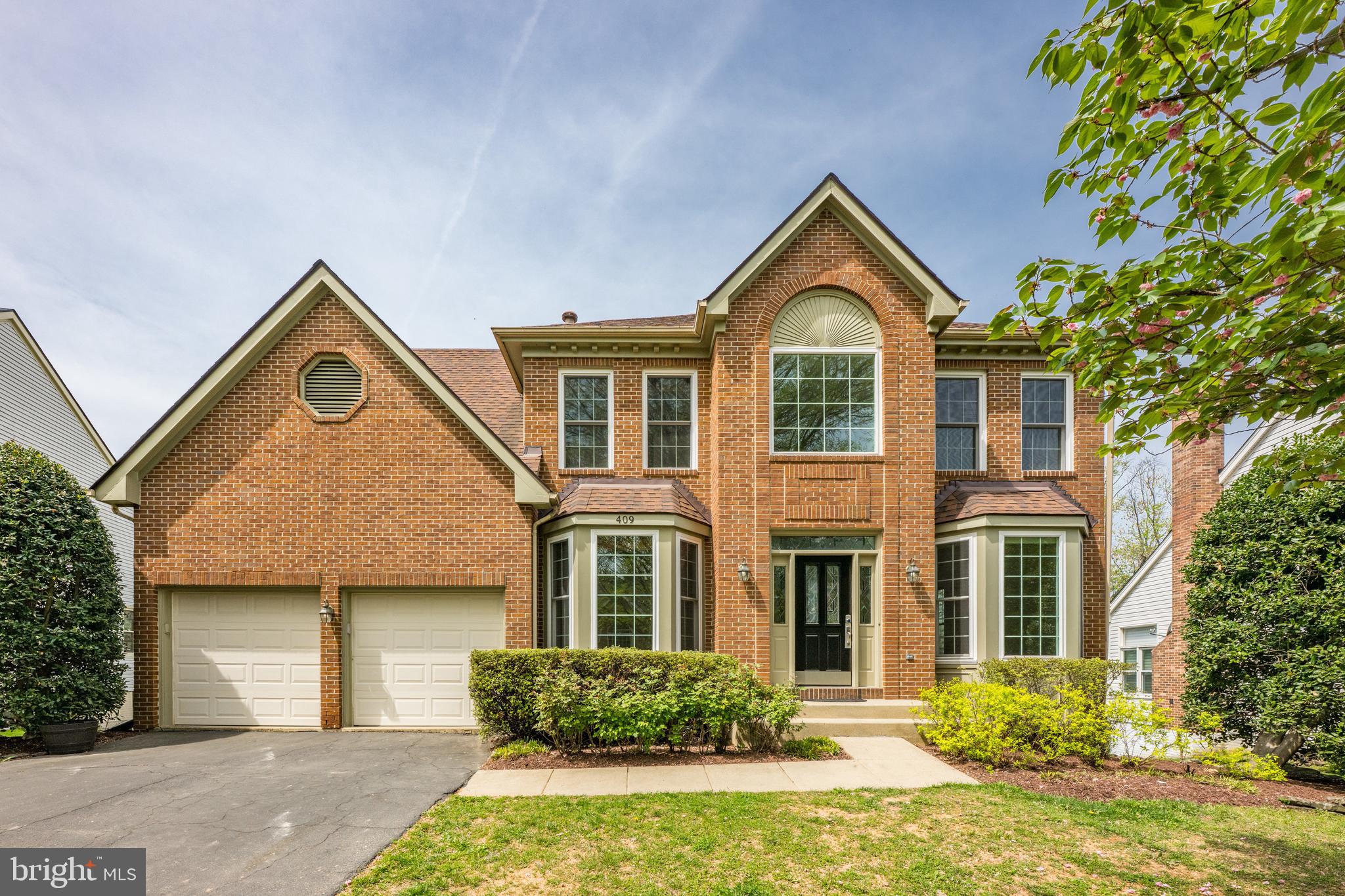 409 Midsummer Drive Gaithersburg, MD 20878 - Photo 2 of 41 a front view of a house with yard and green space