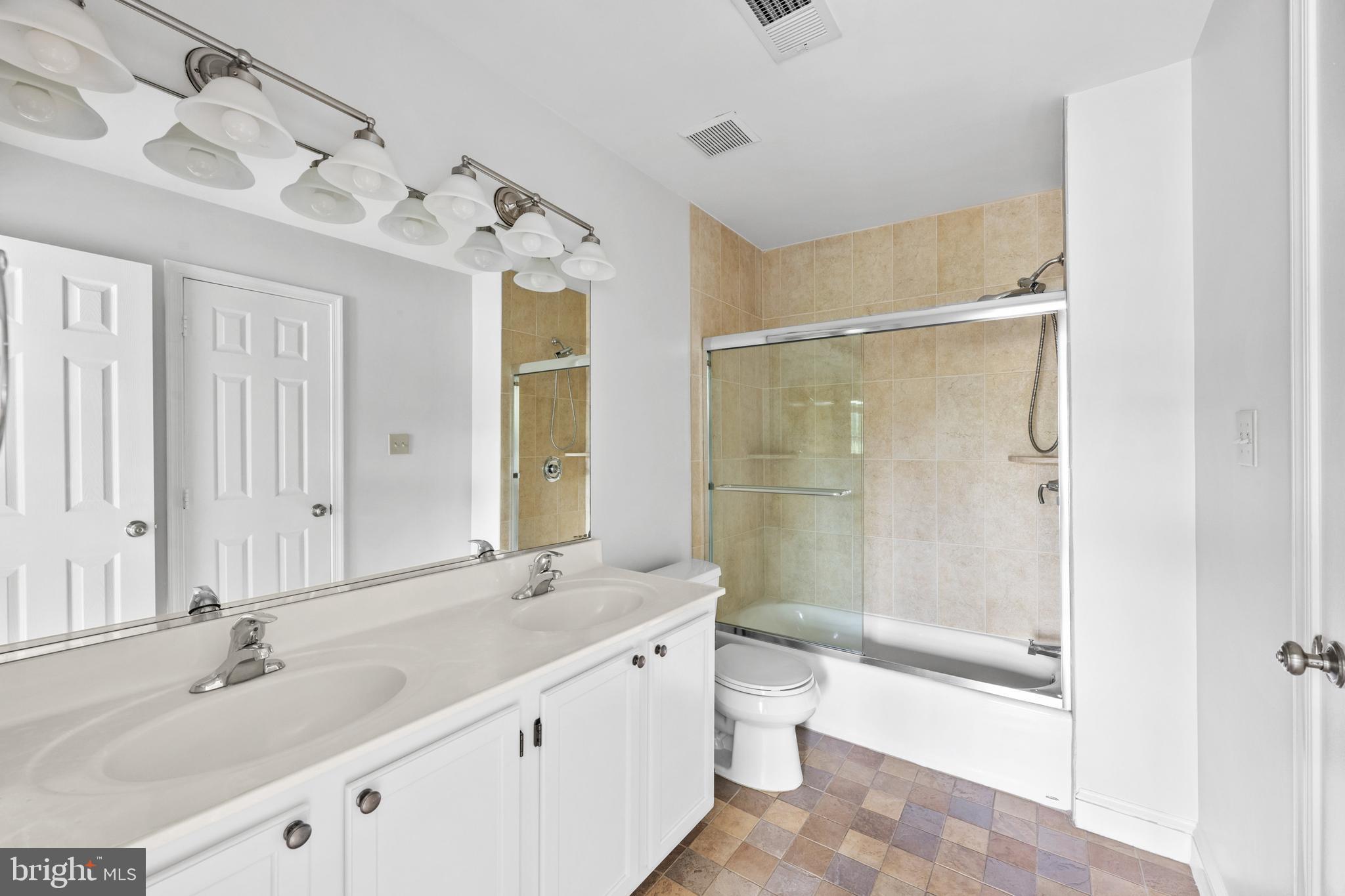 409 Midsummer Drive Gaithersburg, MD 20878 - Photo 30 of 41 a bathroom with a double vanity sink mirror double shower and a bathtub