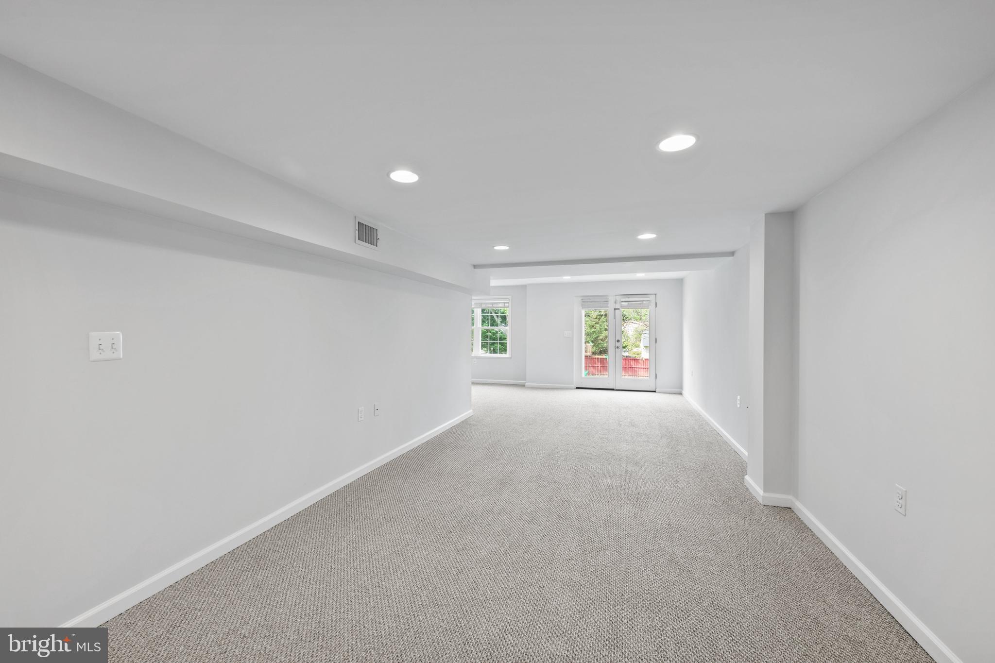 409 Midsummer Drive Gaithersburg, MD 20878 - Photo 31 of 41 a view of a big room with wooden floor and windows