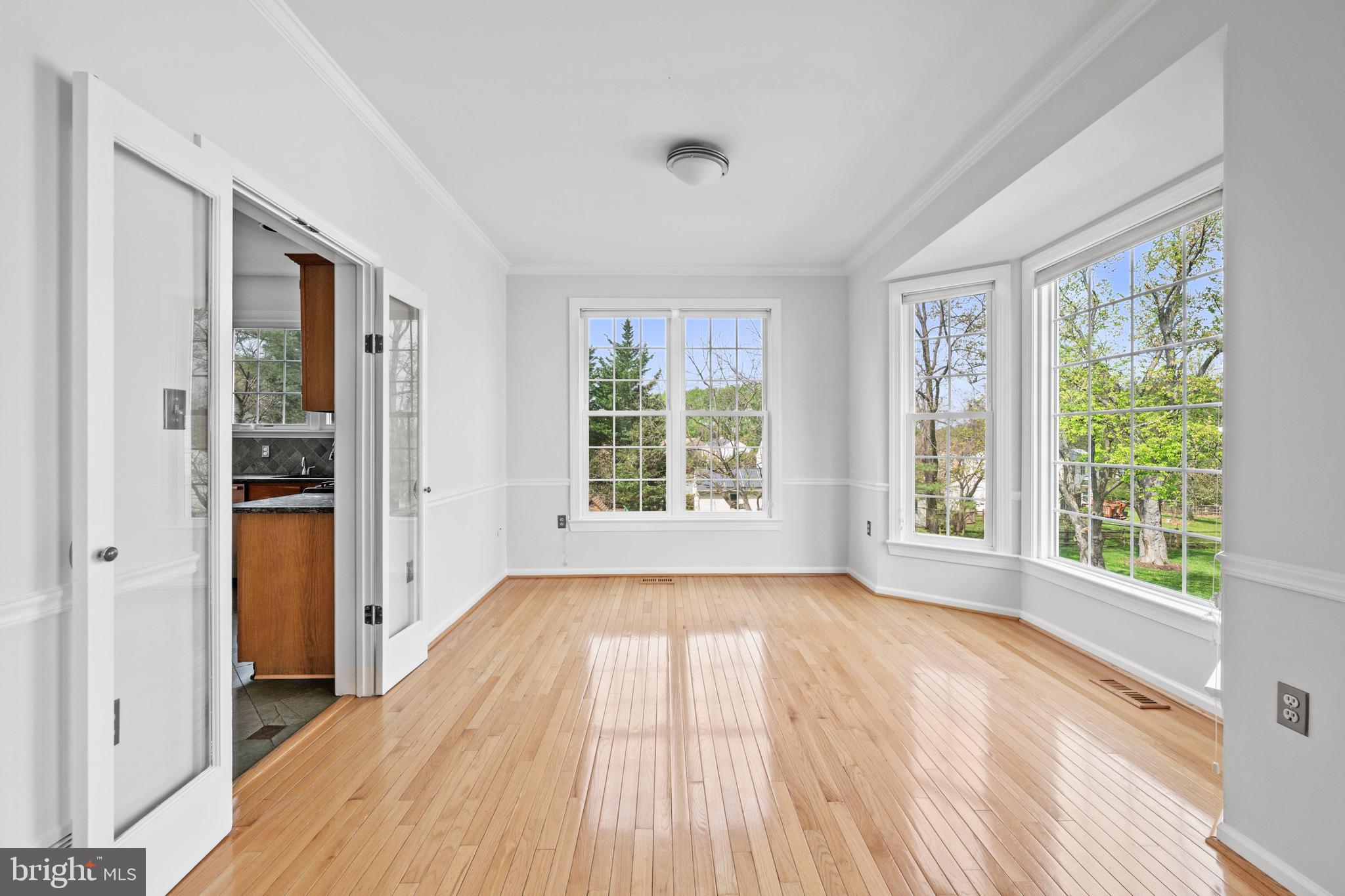 409 Midsummer Drive Gaithersburg, MD 20878 - Photo 6 of 41 a view of a room with wooden floor and windows
