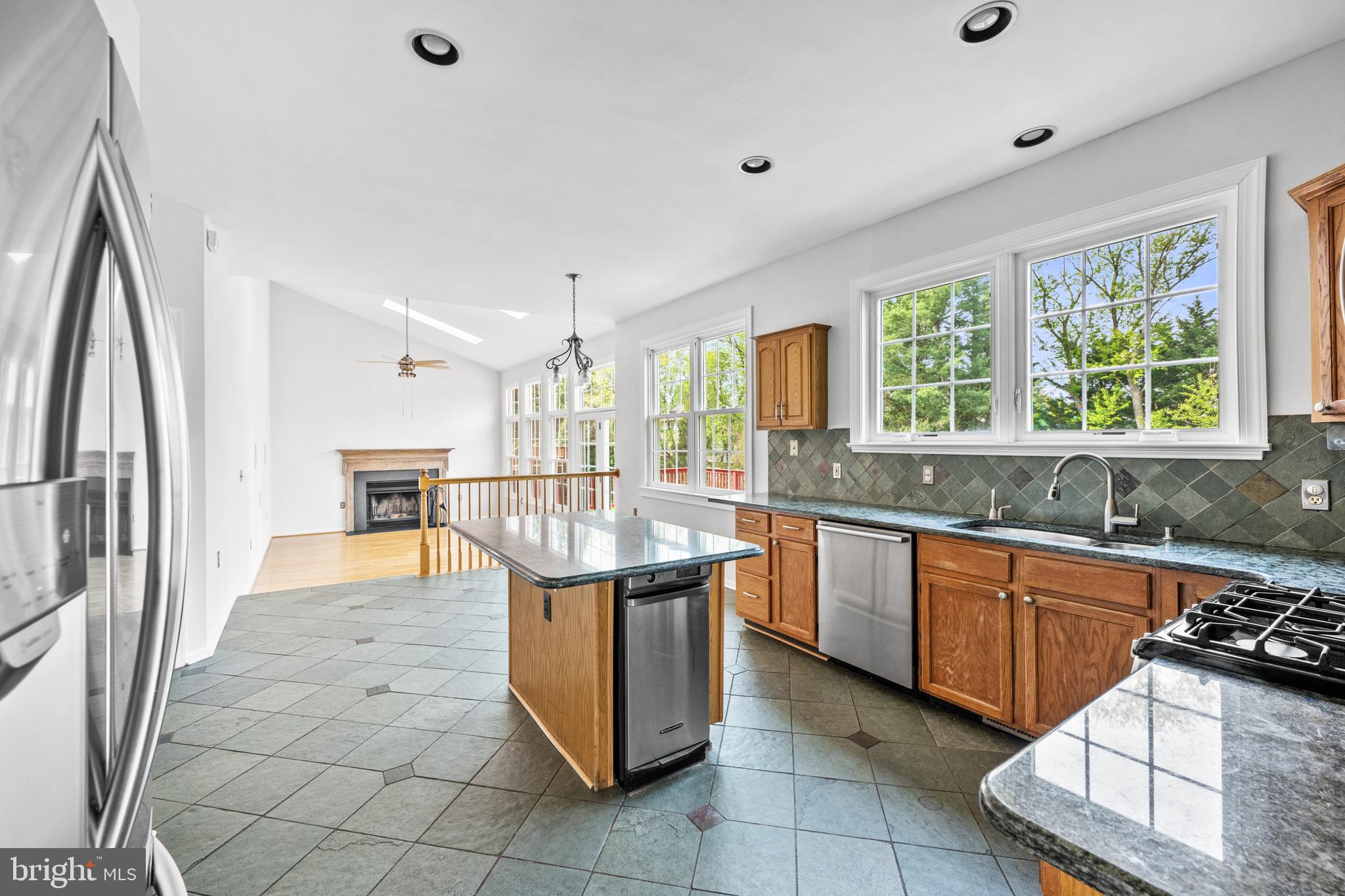 409 Midsummer Drive Gaithersburg, MD 20878 - Photo 8 of 41 a kitchen with granite countertop a sink and a refrigerator