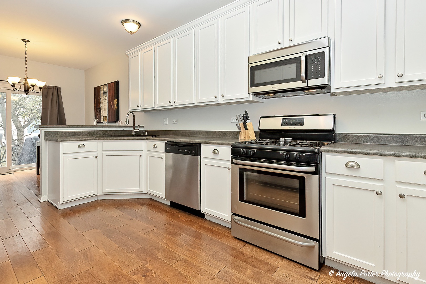 360 Tower Drive Hainesville, IL 60030 - Photo 4 of 22 a kitchen with cabinets stainless steel appliances and wooden cabinets