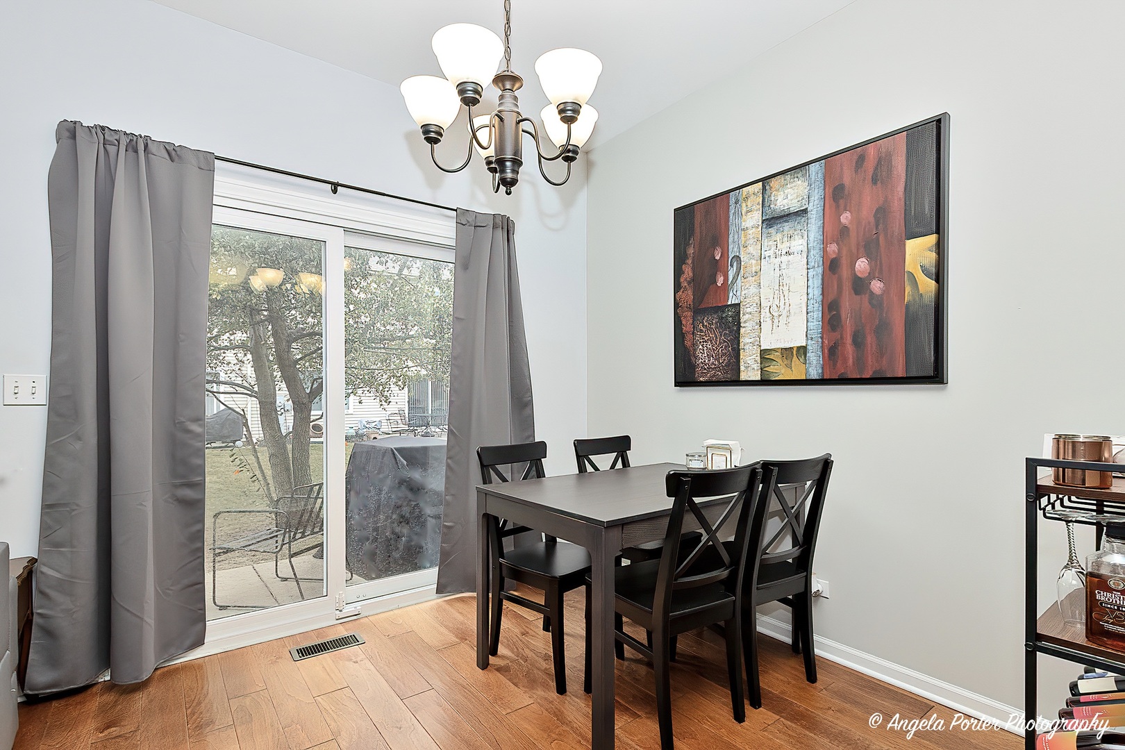 360 Tower Drive Hainesville, IL 60030 - Photo 8 of 22 a view of a dining room with furniture wooden floor and chandelier