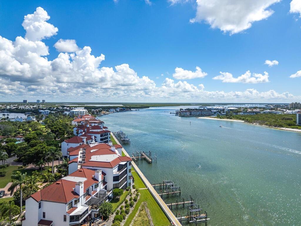421 La Peninsula Boulevard, Unit 421 Naples, FL 34113 - Photo 16 of 18 a view of a lake with a city