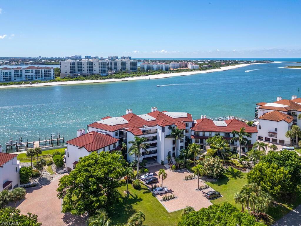 421 La Peninsula Boulevard, Unit 421 Naples, FL 34113 - Photo 17 of 18 an aerial view of a house with a lake view