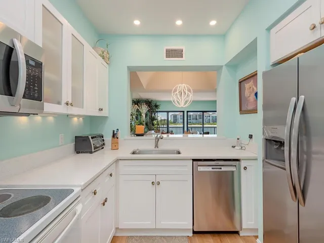 a kitchen with stainless steel appliances a refrigerator sink and cabinets