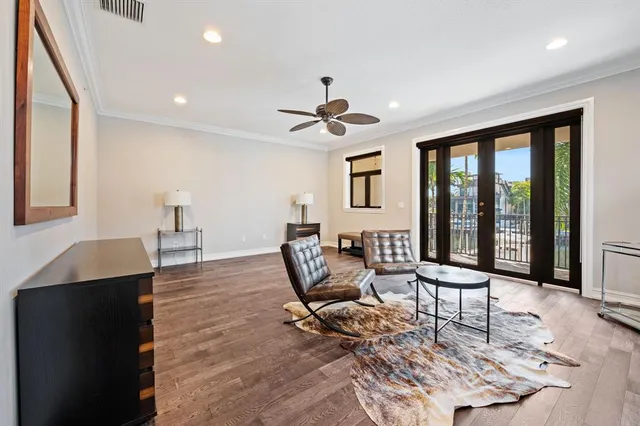 a living room with furniture and large windows