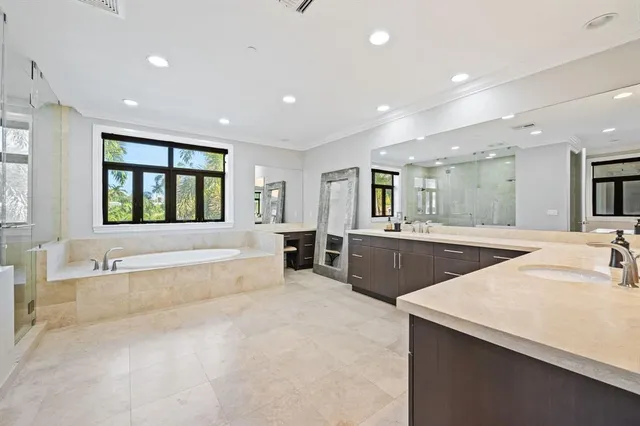 a large spacious bathroom with a large tub and sink