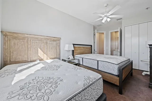 a bedroom with a large bed and a chandelier