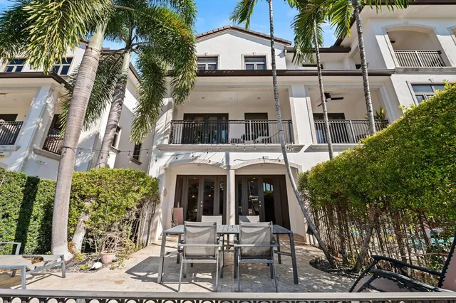 a view of a building with a yard and sitting area