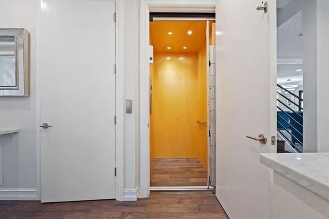 a view of walk in closet with wooden floor