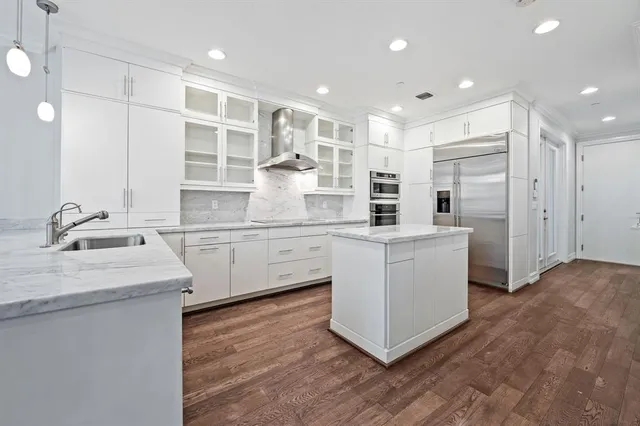 a kitchen with white cabinets and sink