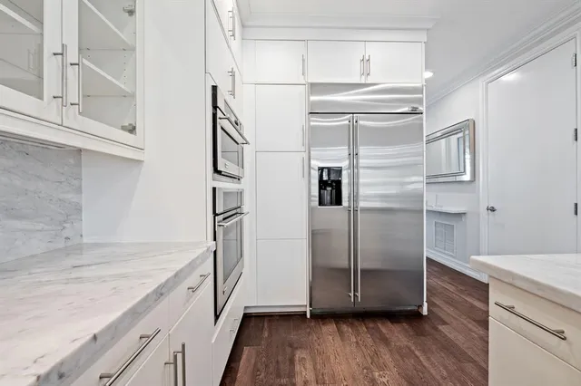a kitchen with stainless steel appliances granite countertop a refrigerator and a sink