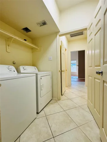 a view of a storage & utility room with dryer and washer