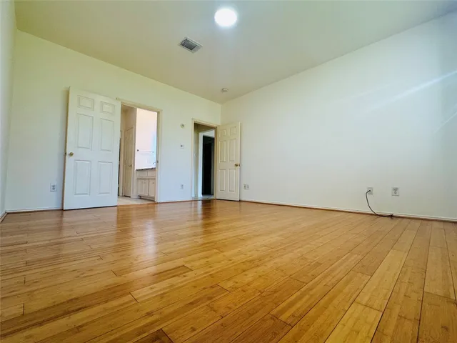 a view of an empty room and wooden floor