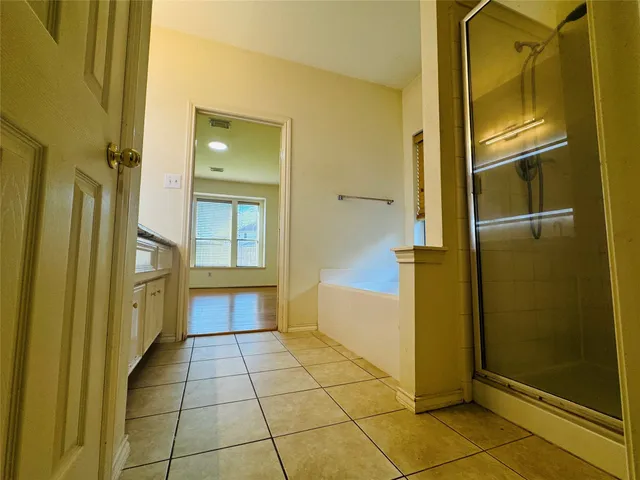 a bathroom with a shower and mirror