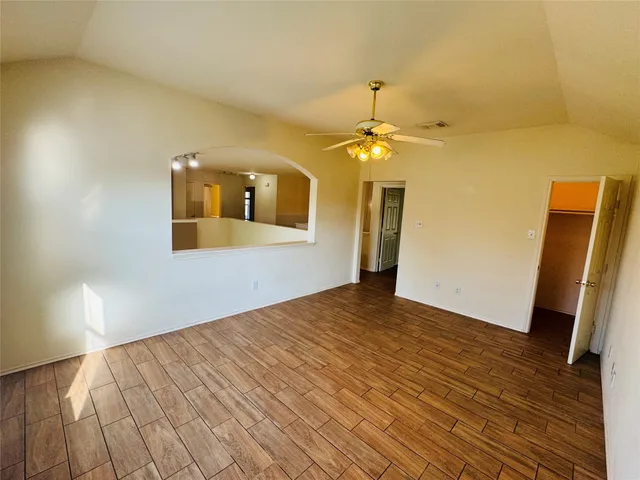 a view of a room with wooden floor