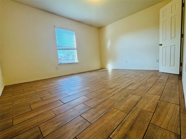 a view of an empty room and wooden floor