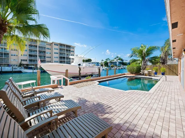 a swimming pool with outdoor seating and yard