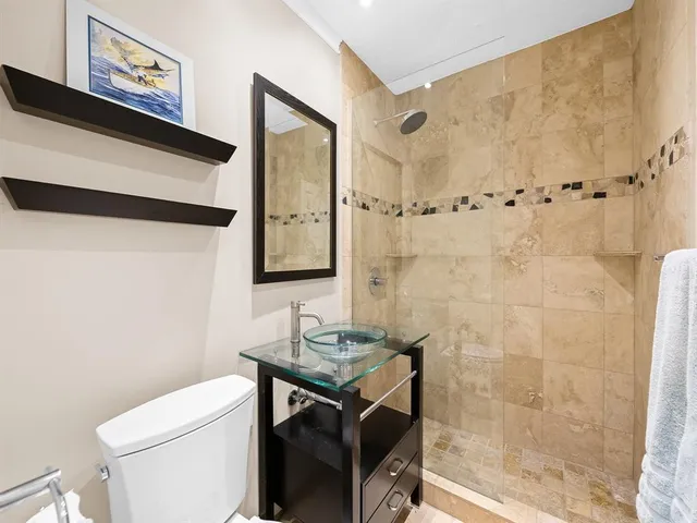 a bathroom with a sink toilet and shower