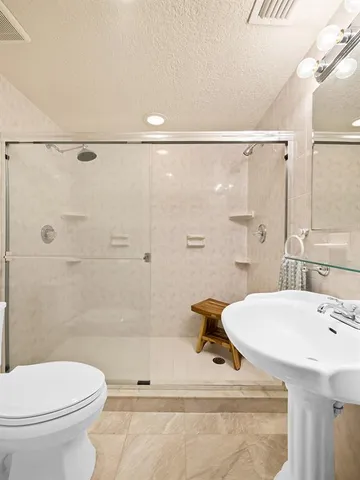 a aerial view of a house with swimming pool and a patio