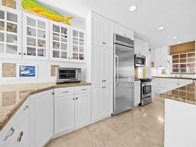 a kitchen with stainless steel appliances and cabinets