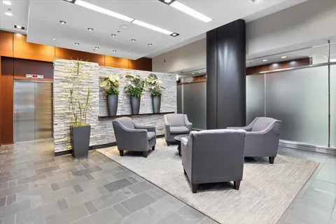 a view of a hallway with wooden floor and entryway