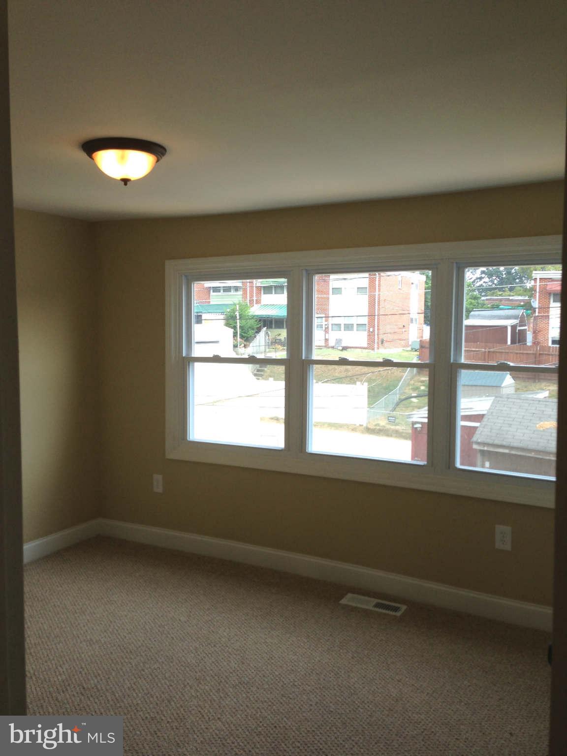 4449 Norfen Road Baltimore, MD 21227 - Photo 14 of 19 an empty room with a window