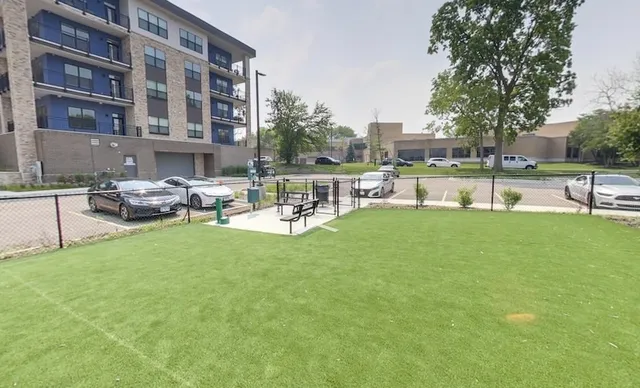 a living room with stainless steel appliances kitchen island granite countertop a sink and cabinets