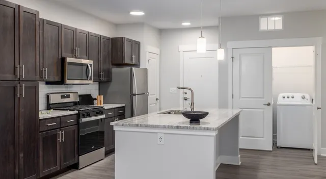 a kitchen with a refrigerator stove and sink