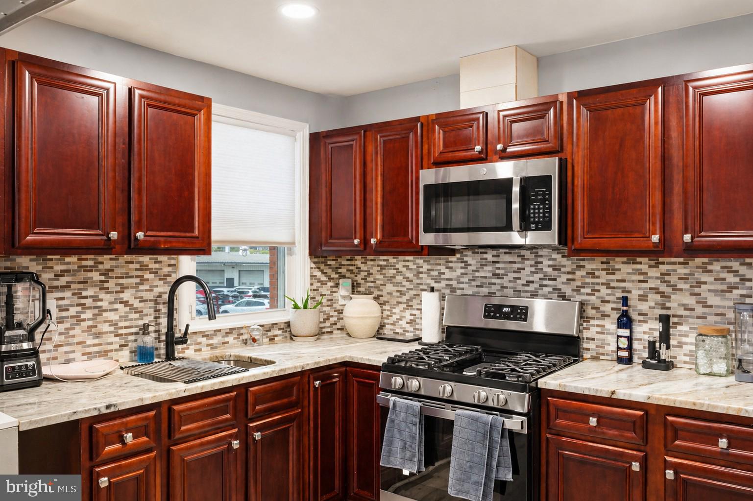 7487 Berkshire Road Baltimore, MD 21224 - Photo 2 of 17 Modern kitchen with rich wood tones.