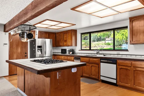a kitchen with stainless steel appliances granite countertop a stove and a refrigerator